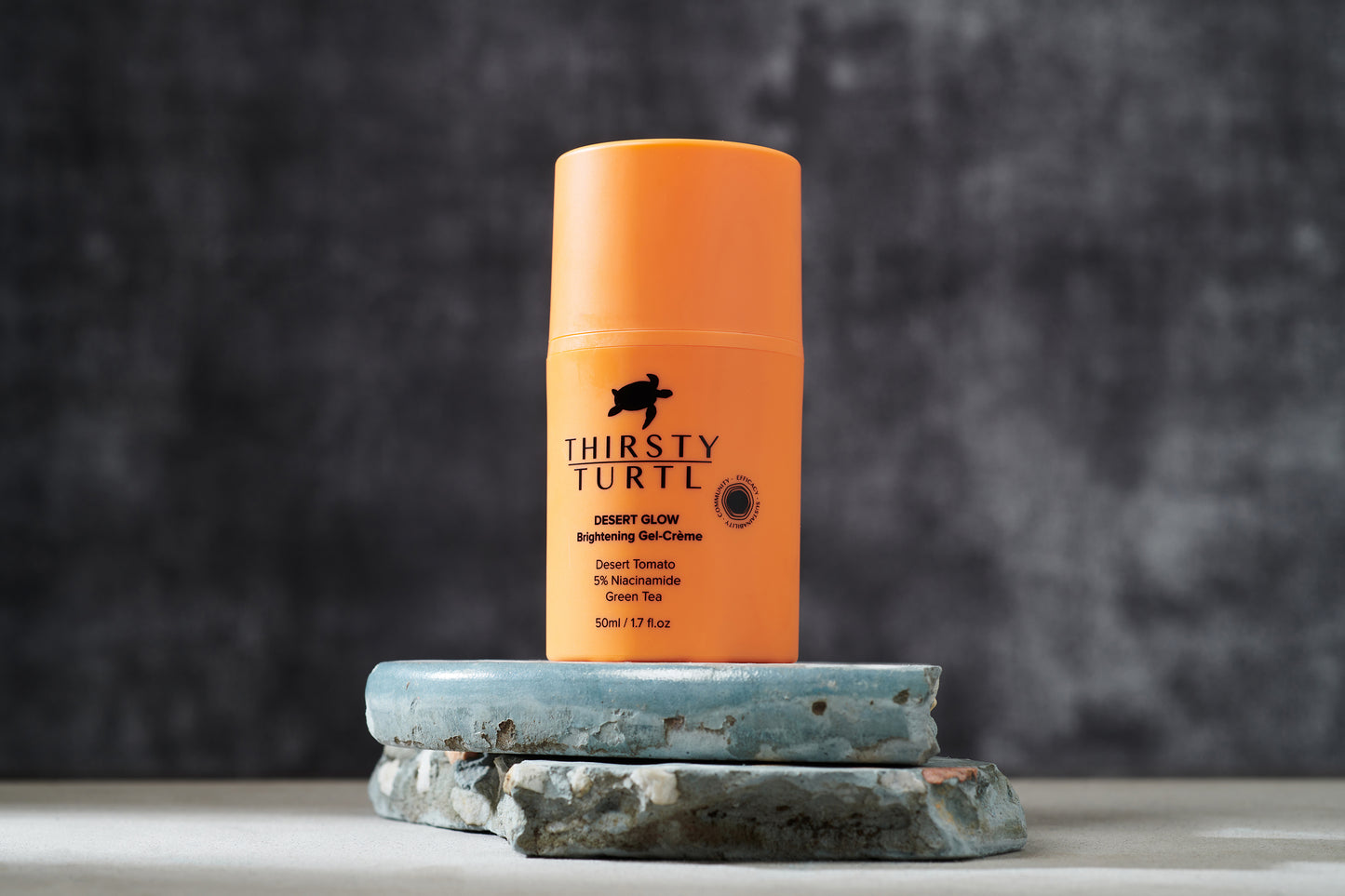 Photo of orange 50ml bottle showing key ingredients such as niacinamide and green tea