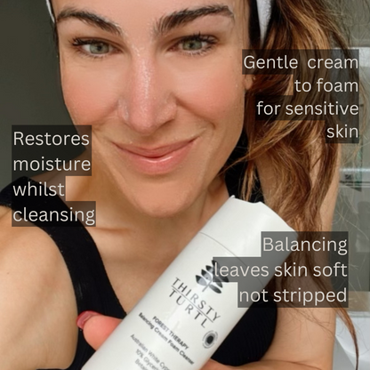 Woman holding 150ml bottle of face cleanser for sensitive skin